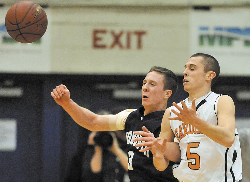 Gardiner High School's Jake Palmer, 5, battles for the loose ball with Yarmouth High School's Joshua Britten, 3, in the first quarter in the Class B State Championship at the Bangor Auditorium Friday night.