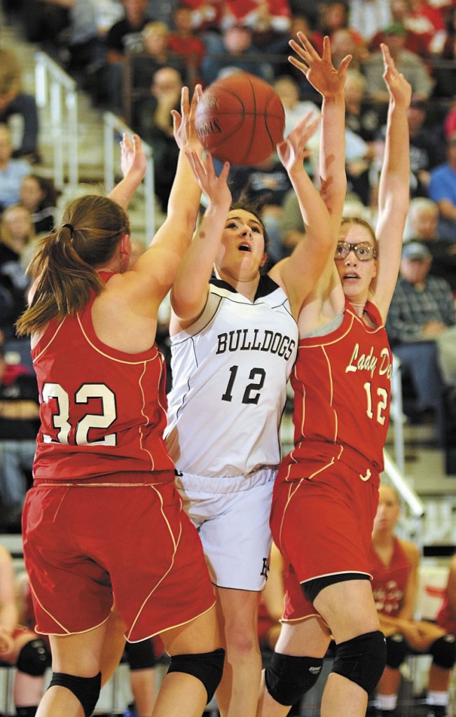Central defenders Brianna Skofield, left, and Samantha Brownell double up on Hall-Dale's Wendy Goldman during the Class C state championship game on Saturday night at the Augusta Civic Center.
