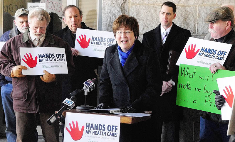 Carol Weston, State Director of Americans for Prosperity - Maine, speaks during a rally held this morning on the granite portico at the Kennebec County Superior Courthouse, in Augusta. The rally was held as the U.S. Supreme Court hears oral arguments over the constitutionality of Obama's health care law. "This is not simply a rally for our healthcare," explained Weston. "This rally is an opportunity for Mainers to voice their opposition to the greatest intrusion into the private lives of American citizens in a generation."