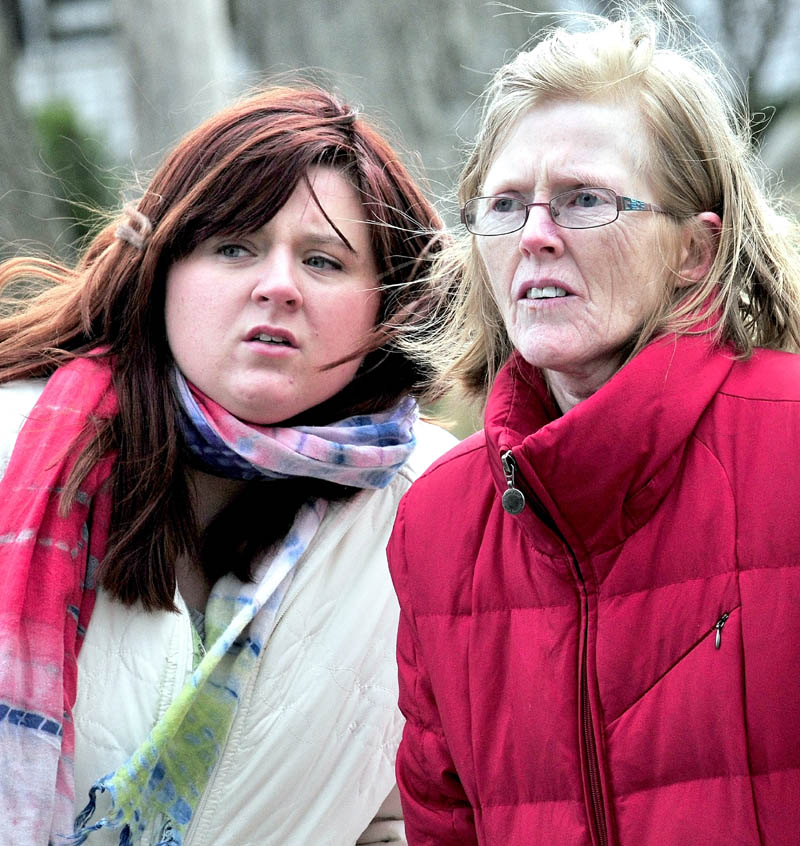 FIRE IN OAKLAND: Kathy Hayes, right, and her daughter Brienne watch as firefighters put out the fire Monday at their home on Church Street.