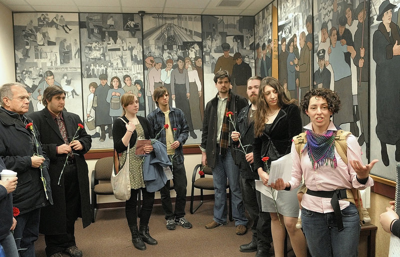 PROTEST: Jessica Graham, of Waterville, leads a memorial prayer on the 100th anniversary of the New York Triangle Shirtwaist Factory fire at an event last year in front of a mural in the Department of Labor lobby in Augusta. A federal judge ruled Friday that Gov. Paul LePage exercised his right to government speech when he removed the mural.