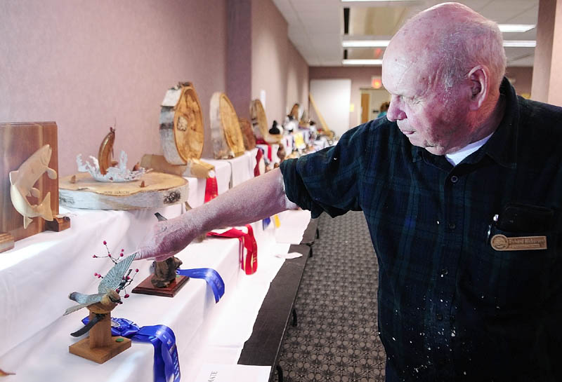 Richard Nickerson talks about his prize-winning Cedar Waxwing carving Friday at the State of Maine Sportsman’s Show at the Augusta Civic Center. The show runs through Sunday.