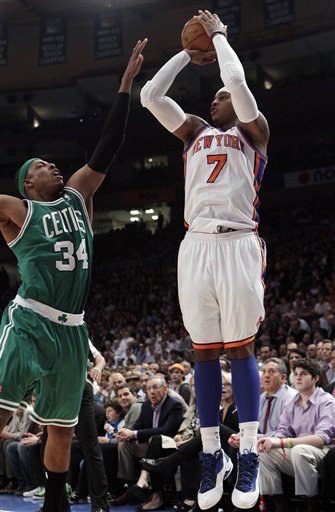 New York Knicks' Carmelo Anthony (7) shoots over Boston Celtics' Paul Pierce (34) during the first half of an NBA basketball game Tuesday, April 17, 2012, in New York. (AP Photo/Frank Franklin II)