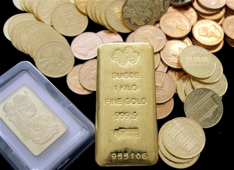 In this March 13, 2008 photo, gold coins and bars are shown at California Numismatic Investments in Inglewood, Calif. The price of gold, which has climbed for years like a blood pressure reading for anxious investors, plunged Wednesday, April 4, 2012 to its lowest level in three months. Gold fell almost $58 to $1,614 per ounce. It has declined 15 percent since September, when it hit a peak of $1,907. It had more than doubled from the financial crisis three years earlier. (AP Photo/Nick Ut)