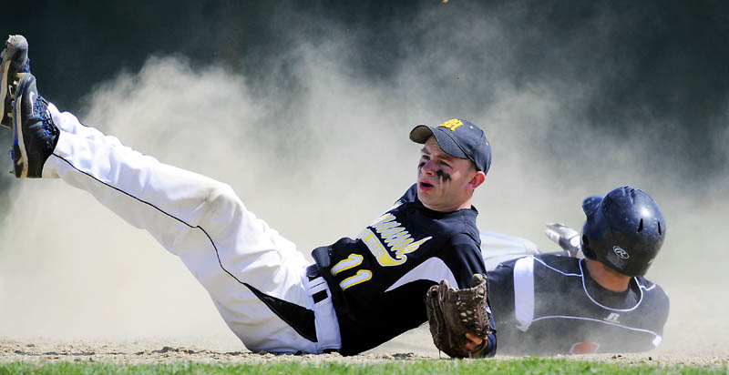 SAFE: Gardiner Area High School’s Frank Chepke, right, slides into second base ahead of a tag by Maranacook Community High School’s Nate Johnson on Monday in Gardiner. The Tigers won the season opener for both teams.