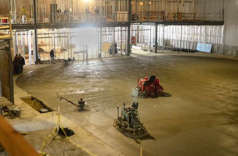 A worker finishes on Wednesday the concrete floor that will be under the ice rink at the new Bank of Maine Ice Vault in Hallowell. The refrigeration pipes are under the 260 yards of concrete and will take 28 days to cure, according to rink manager K.C. Johnson. He said that they plan to have ice by June 1.