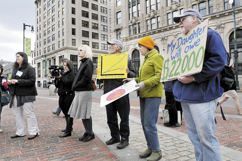 RED INK: Demonstrators protest high student debt at Monument Square in Portland on Wednesday.