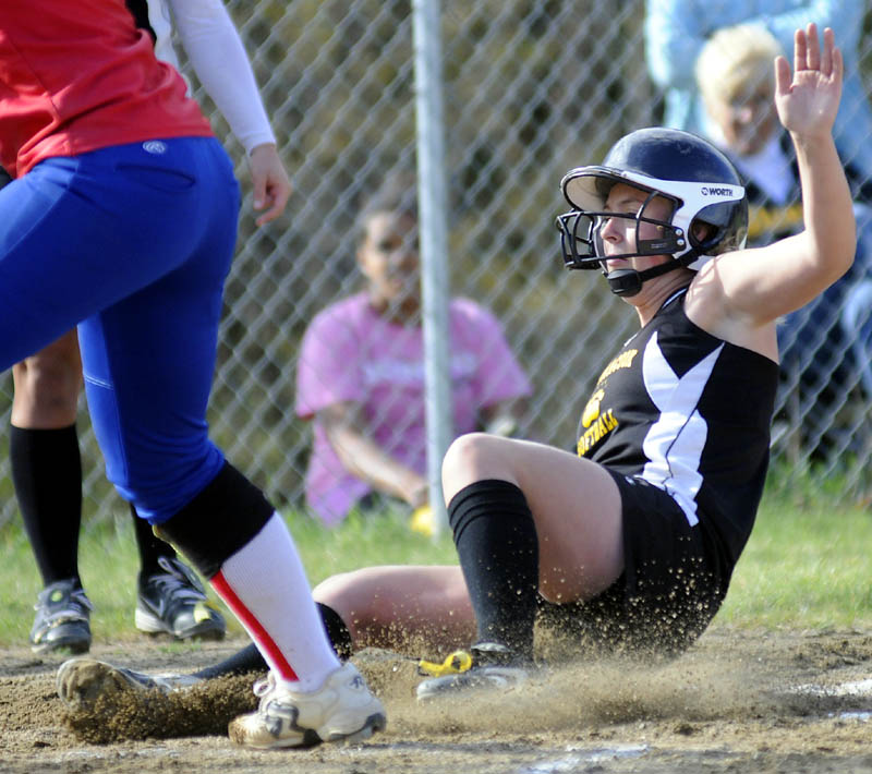 SAFE: Maranacook Community High School’s Ashley Michaud slides safely into home plate during a game against Oak Hill HIgh School on Tuesday in Readfield.
