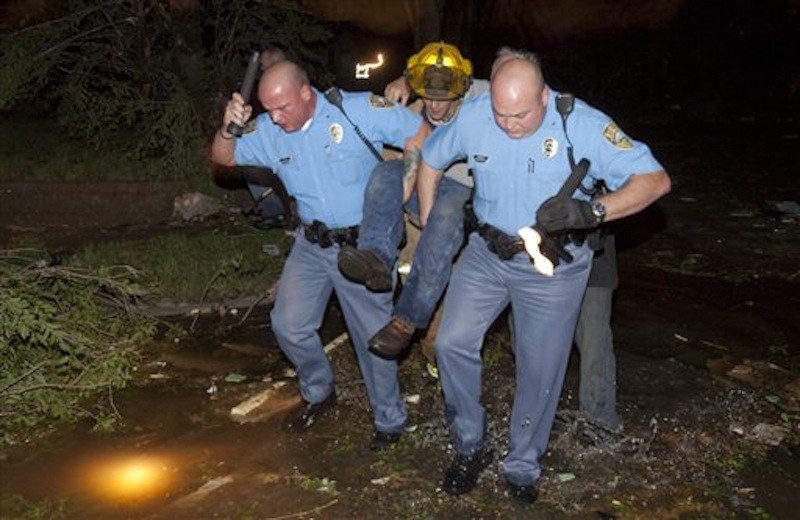 Sheriff's deputies carry out an injured man from a south Wichita neighborhood after a tornado caused massive destruction in Wichita, Kan., late Saturday, April 14, 2012. (AP Photo/The Wichita Eagle, Travis Heying)