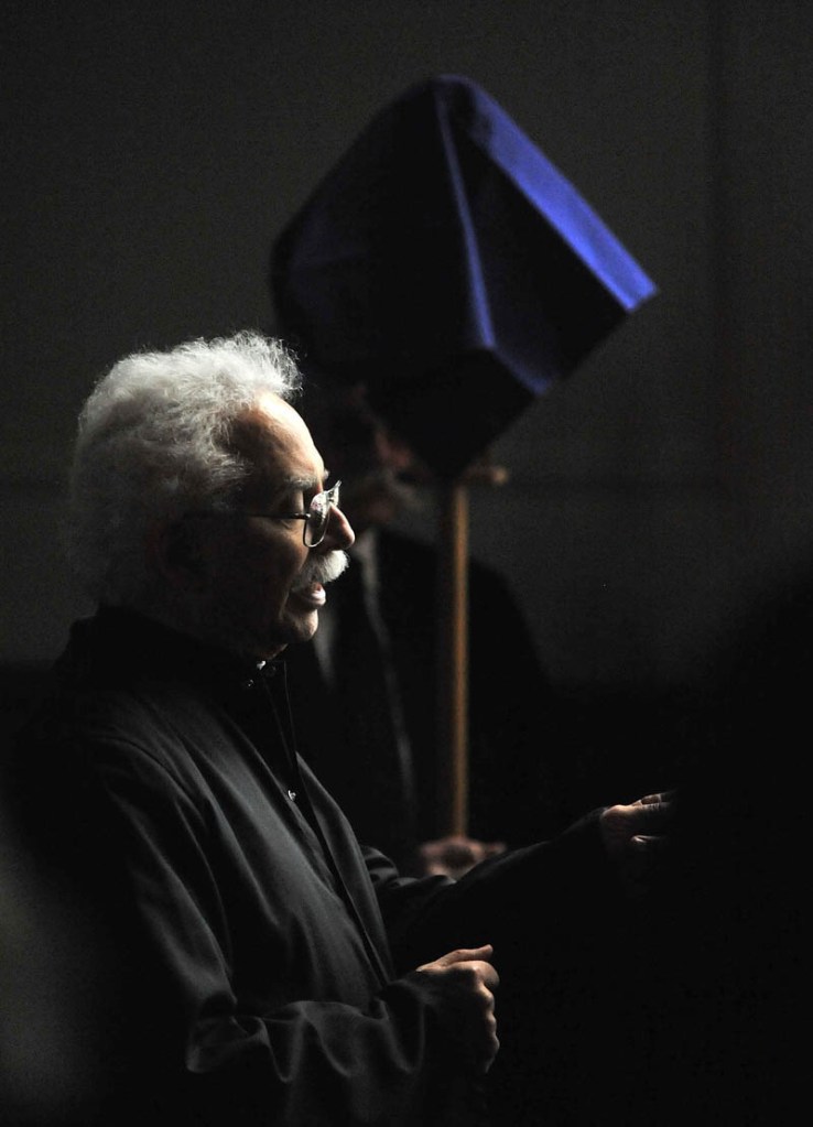 Staff Photo by Michael G. Seamans Deacon Edwin Kalish leads Good Friday Mass at Sacred Heart Church in Waterville. The Holy Trinity Anglican Church rents space at Sacred Heart Church.