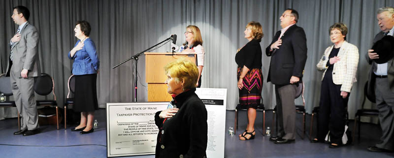 Sen. Lois Snowe-Mello, R-Poland, leads attendants Sunday at the Tax Day Rally in the Pledge of Allegiance in Lewiston. Several members of the Tea Party/Refounders, Patriots, Constitutionalists and John Birch Society were present with Gov. Paul LePage at the event at the Franco-American Heritage Center.