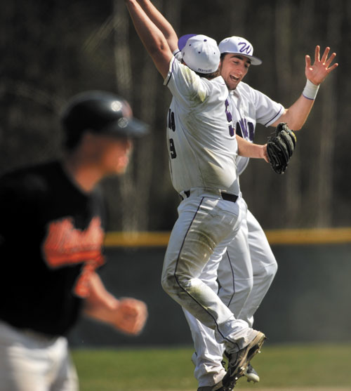 JUMP FOR JOY: Waterville Senior High School pitcher J.T. Whitten, center, celebrates with teammate Matt Lee, right, after the Panthers beat Winslow 6-2 on Wednesday at Winslow High School.