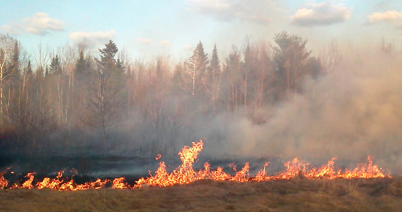 DRY CONDITIONS: The Maine Forest Service is warning about high fire danger after several wildfires statewide were reported Monday, including this one in Clinton. It burned about six acres of grass and brush before it was contained by the agency and Clinton Fire Department Monday evening, according to Lt. Jeffrey Currier of the forest service.