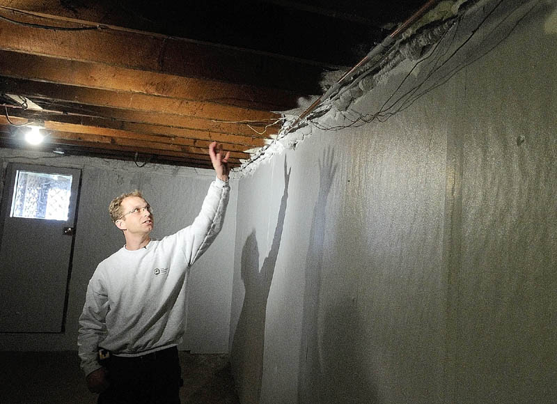 Bo Jespersen, owner of The Breathable Home, talks Wednesday about the insulation his company installed for John Dickens’ 1947 home on Carlisle Street in Augusta. State and federal officials toured the Dickens home before announcing a new loan program to energy improvements. In the Dickens home, there is 2-inch-thick Thermax rigid foam insulation on the concrete walls, while spray foam insulation, painted with a thermal barrier, fills in the gap on top.