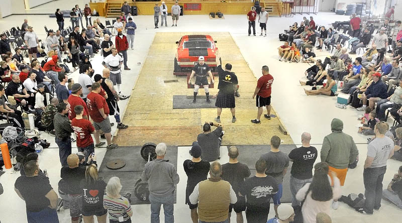 GIVE THAT CAR A LIFT: Matt LeBlanc, of Putnam, Conn., deadlifts a Firebird during the fifth annual Central Maine Strongman competition on Saturday at the Augusta Armory.