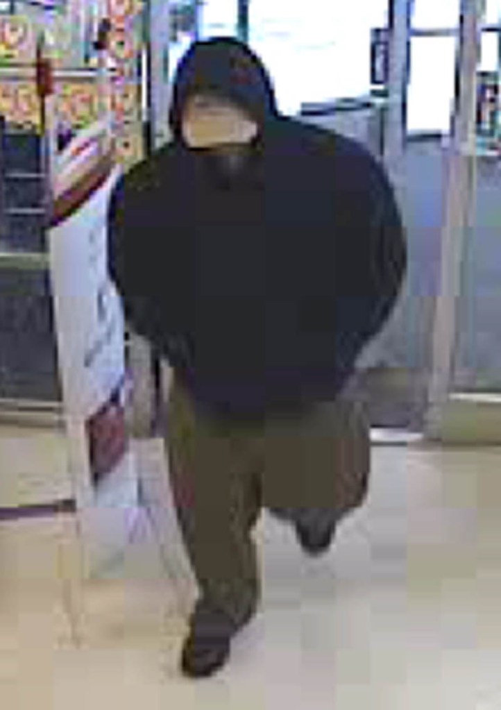 The man who robbed a pharmacy in Winslow on Sunday is seen in a security camera photo from the store.