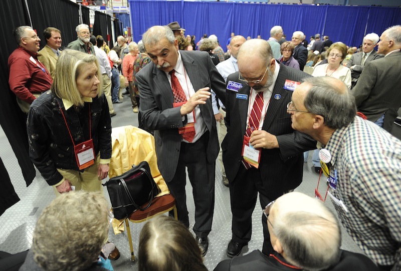 Maine Republican Party Chairman Charlie Webster, second from left, talks with delegates during the Maine Republican Party State Convention on Sunday.