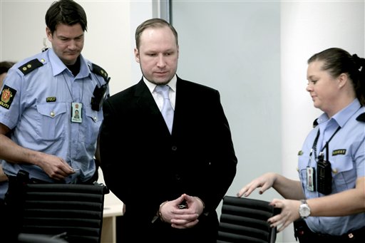 Anders Behring Breivik between 2 police officers prior to taking his seat after a break in the courtroom in Oslo Tuesday morning May 15, 2012. When the trial opened, the self-styled anti-Muslim crusader pleaded innocent to terror charges _ even though he admitted to the facts of the case _ saying he didn't recognize the authority of the court. (AP Photo/Stian Lysberg Solum, Pool)