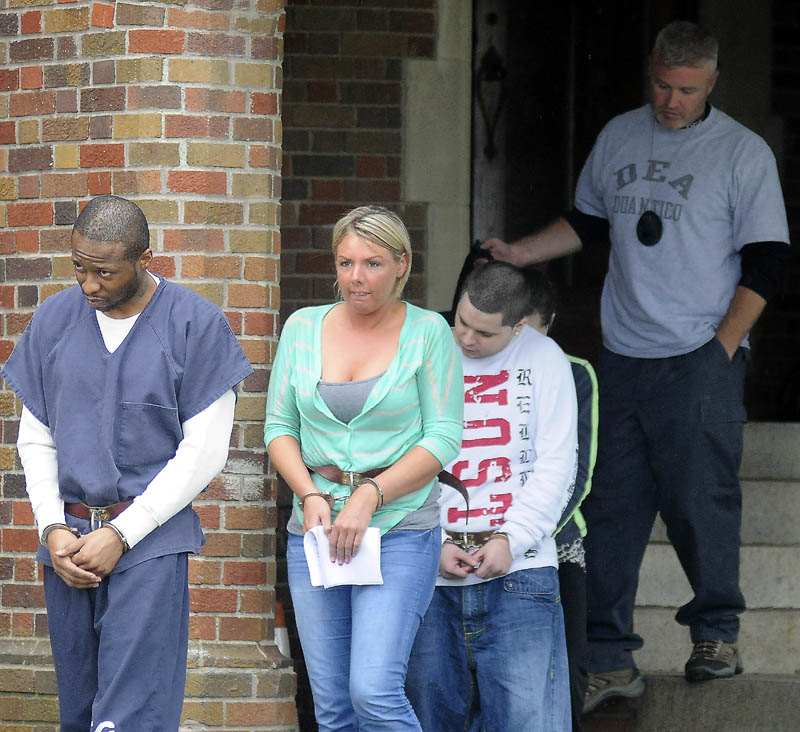 ARRESTS: Maurice McCray, right, leads a line of people arrested Tuesday morning — including Tara Pelletier and Justin LaCroix, at left, by federal and state authorities at the Maine Criminal Justice Academy in Vassalboro. Officers from several agencies said they made 10 arrests across central Maine stemming from a months-long drug investigation. Suspects were processed by federal agents at the Maine Criminal Justice Academy before being sent to jail.