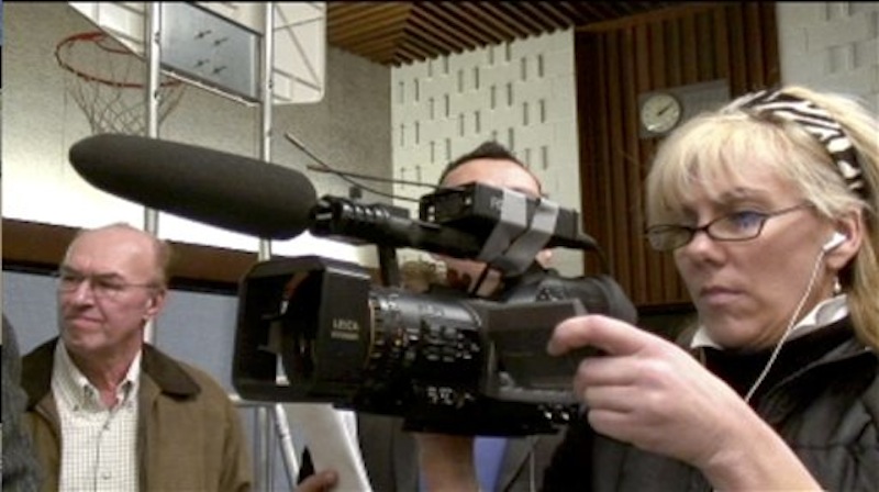 In this file image made from video and provided by Chuck Olsen on Friday, Dec. 29, 2006, Rielle Hunter, right, films John Edwards after a rally in New Hampshire. Hunter billed herself a truth seeker. Then she met John Edwards in the bar of a New York City hotel in February 2006. Their relationship opened the door to a landslide of lies, most notably that the relationship existed at all, and that the child it produced was his. Edwards' truthfulness now lies at the heart of his campaign finance trial, with the former Senator insisting he had no idea that money from a pair of wealthy benefactors was being spent to hide Hunter and keep her away from tabloids. (AP Photo/Chuck Olsen)