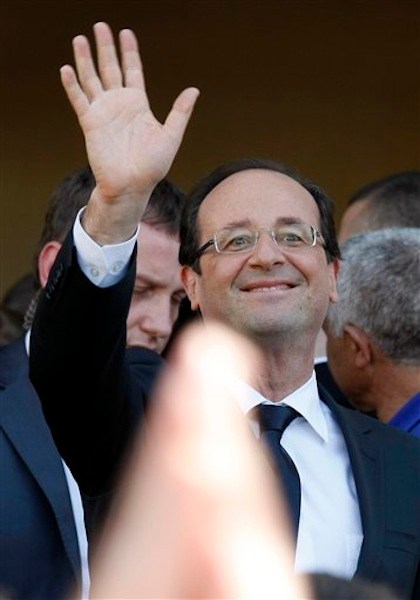 Socialist Party candidate for the presidential election Francois Hollande waves after visiting a polling station near Tulle, central France, Sunday, May 6, 2012. (AP Photo/Lionel Cironneau)