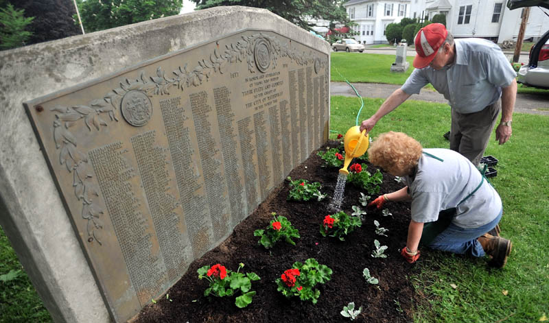 Louie and Linda Huard plant fresh flowers and plants at Veterans’ Memorial Park in Waterville Saturday. The Huards are members of the Waterville Gardening Club and, with donated money and supplies, members of the club volunteer their time to dress up community parks.