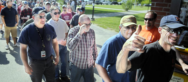 A member of Local S6 gives the thumbs up Sunday before voting at the Augusta Civic Center on a new contract with Bath Iron Works. The 3,200 members of the International Association of Machinists and Aerospace Workers union voted to ratify a four-year contract with the ship builder that improves pensions and wages and "holds the line" on health care costs for employees, according to members.