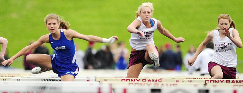 ON THE MOVE: Madison’s Monica Ouellette, left, leads Monmouth’s Melissa Brassard, center, and Tiffany Pease in the 100-meter hurdles final during the Mountain Valley Conference champion on Friday at Alumni Field in Augusta. Ouellette won in a time of 18.00 seconds.