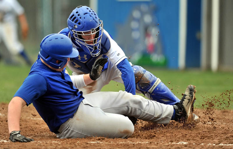 BANG, BANG PLAY: Madison catcher Rhett McKenney, back, tags out Mt. Abram’s Arthur Ryan at home plate in the second inning Wednesday in Madison.