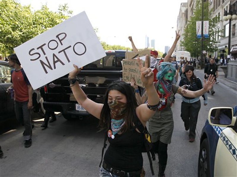 Protesters block traffic on Michigan Ave., as they march through the city during a demonstration Friday, May 18, 2012, ahead of this weekends' NATO summit in Chicago. Thousands of nurses and other protesters gathered for the noisy but largely peaceful demonstration with a broad spectrum of causes, from anti-war activists to Occupy protesters to a Chicago Women's AIDS project. The demonstrations Friday were the largest yet ahead of a two-day NATO summit that is expected to draw even larger protests. (AP Photo/Charles Rex Arbogast)