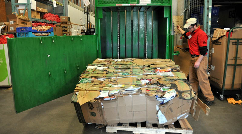 Justin Tremblay, 21, handles a bundle of recycled cardboard at the Skowhegan Hannaford Friday. Skowhegan Hannaford received first-in-Maine environmental recognition.