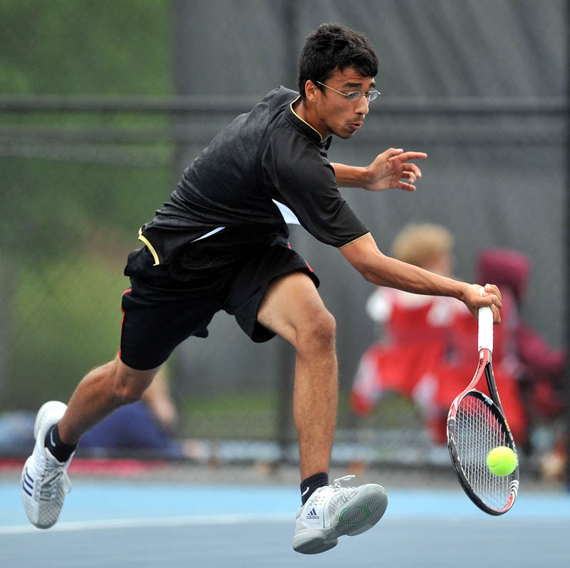 MOVING ON: Messalonskee’s Jai Aslam returns a shot by Kennebunk’s Charlie Merry during the second round of the singles tennis state tournament Friday in Waterville. Aslam won 6-2, 6-0 to advance to the round of 16.
