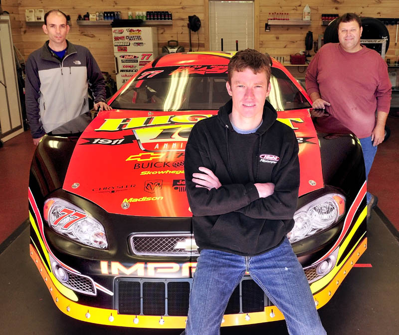 READY TO GO: Race car driver Cassius Clark, front, hopes to put a successful season together after a two-year break from the sports. He has signed on with car owner Corey Hight, left, and hired Brian Burgess as his crew chief.