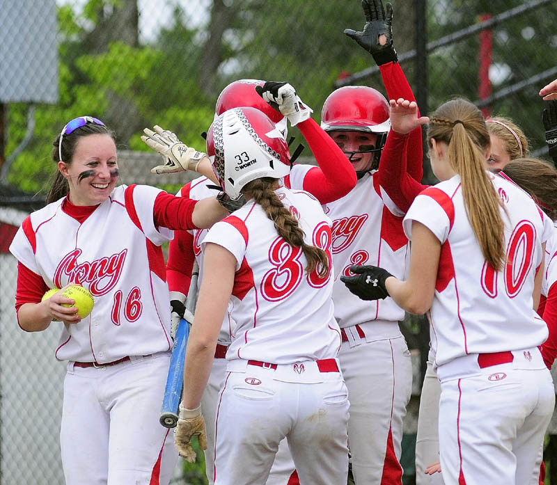Staff photo by Joe Phelan Cony teammates congratulate Nicole Rugan as she crosses the plate after hitting a very long two run homer in third inning of a game on Wednesday evening at Cony Family Field in Augusta.