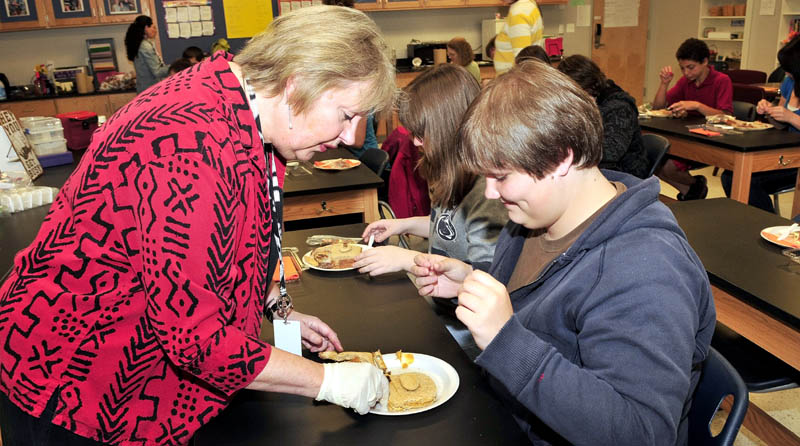 HEALTHY FOOD: Waterville Senior High School teacher Christine Rasmussen helps student Haley Friend assemble a healthy and balanced Bento sandwich as part of Disease and Health Day at the school on Wednesday.