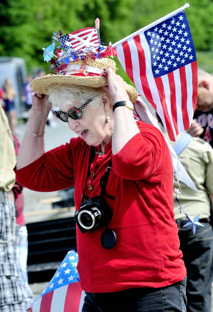 MEMORABLE ATTIRE: Kathy Dall of Carriege House Art organization prepares for the Waterville Memorial Day parade by putting on a patriotic outfit on Monday.