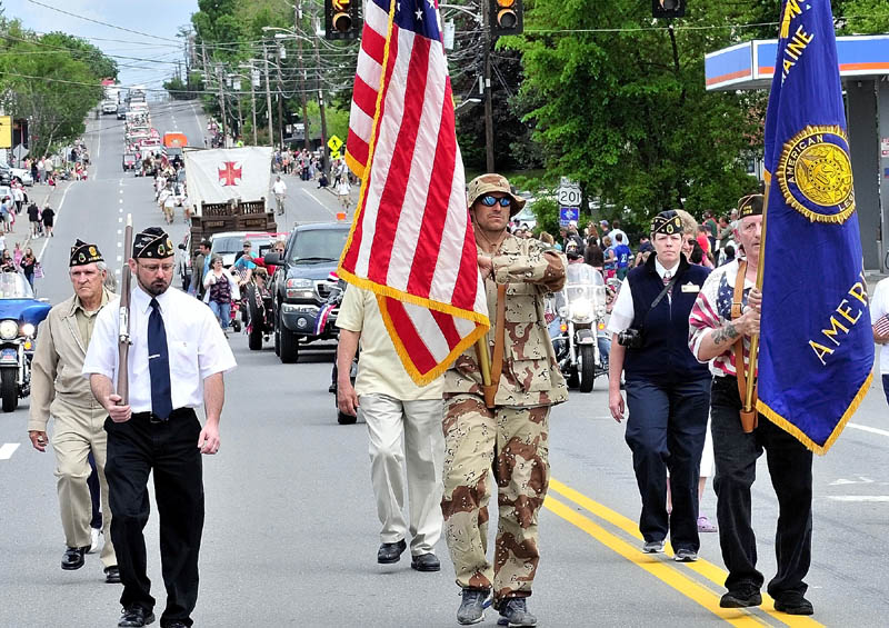 MEMORIAL MARCH: Participants in the Memorial Day parade march down Madison Avenue in Skowhegan on Monday.
