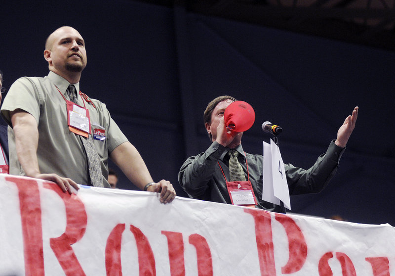 Bill Crandall of Farmington shouts out to the convention chair as he objects to the proceedings during the Maine Republican State Convention at the Augusta Civic Center on Sunday. At left is Hutch McPheters of Wilton.