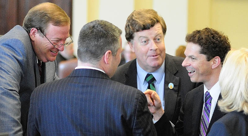 Staff photo by Joe Phelan LEADERSHIP CONFERENCE: Senate President Kevin Raye, R-Perry, left, Majority Leader Jon Courtney, Senate Minority Leader Barry Hobbins, D-Saco, Assistant Minority Leader Justin Alfond and Assistant Majority Leader Deb Plowman confer at the Senate rostrum before the bond debate began on Wednesday in the State House in Augusta.