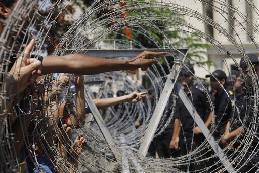 Protesters point at soldiers in front of the Supreme Constitutional Court in Cairo on Thursday after Egypt's highest court ruled that Hosni Mubarak's last prime minister can stay in the presidential race.