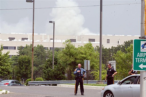 Police block off access to the Federal Aviation Administration's William J. Hughes Technical Center, in Egg Harbor Township, N.J., during a fire on Friday. The FAA says the fire at the building at Atlantic City International Airport made some traffic flow systems unavailable. The agency says those functions were transferred to a backup system.