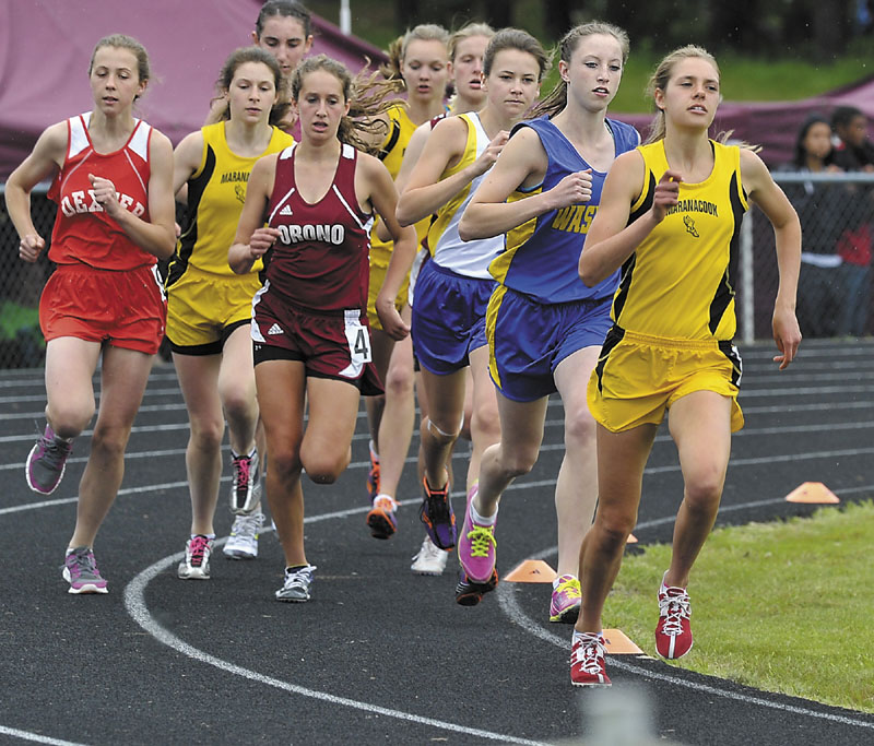 SETTING THE PACE: Abby Mace of Maranacook leads the pack ahead of Carsyn Koch of Washburn in the first turn of the 1,600-meter run at the Class C track and field state championship meet Saturday in Augusta. Mace led until late in the race when Koch passed her for the win.
