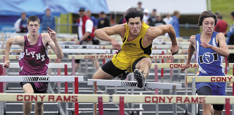 UP AND OVER: Taylor Watson of Maranacook wins the 100-meter hurdles at the Class C track and field state championship meet Saturday at Cony High School in Augusta.