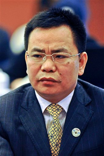 Businessman Lin Chunping attends a press conference in Wenzhou, in eastern China's Zhejiang province. In China, awash with fake iPhones, pirated DVDs of Hollywood blockbusters and knockoff Louis Vuitton bags, 41-year-old rice trader Lin took fakery to a whole new level: He invented a U.S. bank and claimed he bought it.