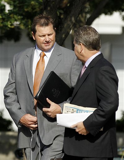 Former Major League Baseball pitcher Roger Clemens, left, arrives at federal court for his perjury trial today in Washington.