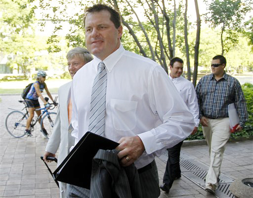 Former Major League Baseball pitcher Roger Clemens, accompanied by his attorney Rusty Hardin, left, arrives at federal court in Washington today.