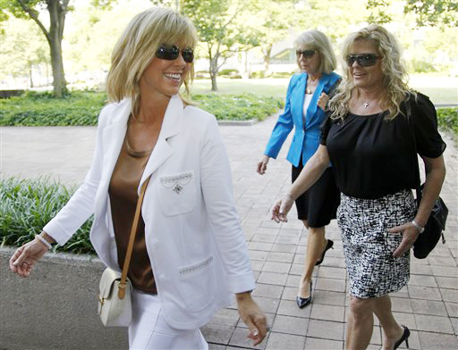 Debbie Clemens, left, wife of former Major League Baseball pitcher Roger Clemens, arrives at federal court in Washington today.