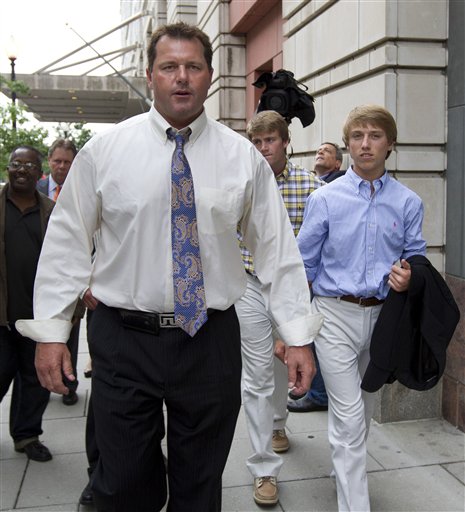Former Major League Baseball pitcher Roger Clemens, left, gestures as he leaves Federal Court in Washington with sons, Kacy, center back, and Kody, right, in this June 12, 2012, photo.