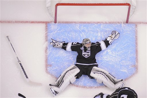 Los Angeles Kings goalie Jonathan Quick (32) falls backward as he defends against the New Jersey Devils in the third period during Game 4 of the NHL hockey Stanley Cup finals, Wednesday, June 6, 2012, in Los Angeles. The Devils won 3-1. (AP Photo/Mark J. Terrill)