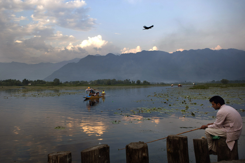 Kashmiri Muslims fish on the shore of Nageen Lake on the outskirts of Srinagar, India. What is the value of clean water to a nation's economy?